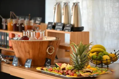 a buffet with a plate of fruit on a table at Hôtel Alivi Di Santa Giulia in Porto-Vecchio