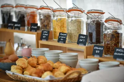 a display of bread and other food items on a table at Hôtel Alivi Di Santa Giulia in Porto-Vecchio