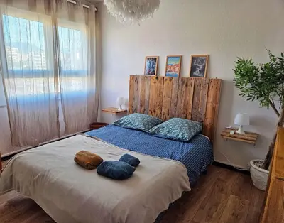 a bedroom with a bed with two towels on it at Appartement entier, climatisé, vue mer in Ajaccio