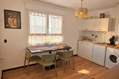 a kitchen with white cabinets and a microwave at Appartement entier, climatisé, vue mer in Ajaccio
