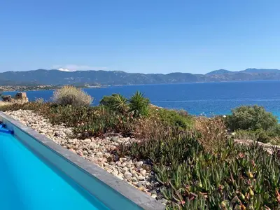 a swimming pool with a view of the water at Casa Turrigiani in Sagone