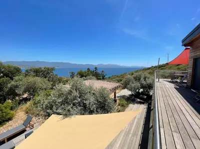 a wooden deck with a covering on a house at Casa Turrigiani in Sagone