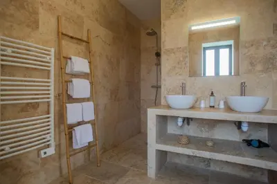 a bathroom with two sinks and a mirror at A PIANARELLA in San-Gavino-di-Carbini