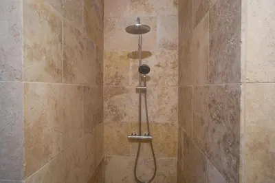 a shower with a shower head in a bathroom at A PIANARELLA in San-Gavino-di-Carbini