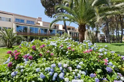 a garden of flowers in front of a building at Residence Club Marina Viva in Porticcio