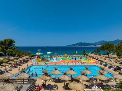 a view of a pool at a resort with umbrellas at Residence Club Marina Viva in Porticcio