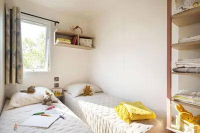 a kitchen and living room with a table and chairs at Camping La Baie des Voiles in Porto-Vecchio