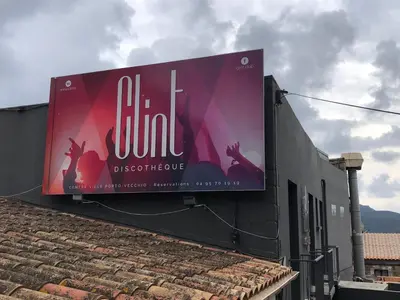 a billboard on the side of a building at Palombaggia in Porto-Vecchio