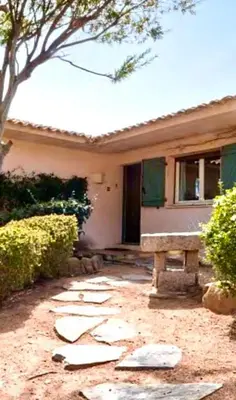 a house with a bench in front of it at Palombaggia in Porto-Vecchio
