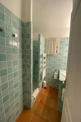 a bathroom with blue tiles on the walls and a sink at Palombaggia in Porto-Vecchio