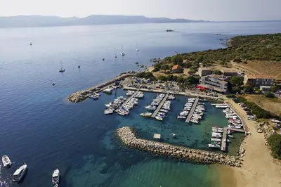 an aerial view of a harbor with boats in the water at Le Golfe in Porto Pollo