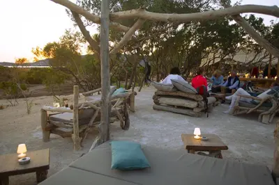 a group of people sitting in chairs and tables at Le Golfe in Porto Pollo