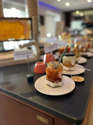 a buffet line with plates of food on a counter at Le Golfe in Porto Pollo