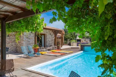 a pool in a backyard with chairs and a house at Villa SoleLuna chambre Jeanne in Bonifacio