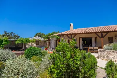 a house with a garden in front of it at Villa SoleLuna chambre Jeanne in Bonifacio