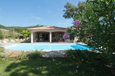 a house with a swimming pool in a yard at villa standing piscine chauffée privée in Sainte-Lucie de Porto-Vecchio