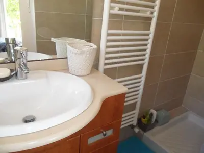 a bathroom with a sink and a mirror at Villa BRIMI in Ghisonaccia