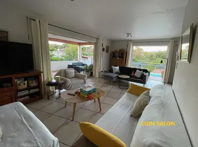 a living room with a couch and a tv at Villa BRIMI in Ghisonaccia