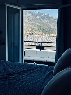 a bedroom with a view of a mountain through a window at Casa Petra SALGA in Corte