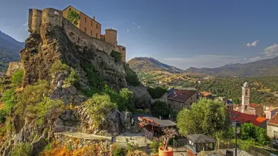 a castle on the side of a mountain at Casa Petra SALGA in Corte