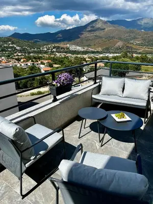 a balcony with chairs and tables and a view at Casa Petra SALGA in Corte
