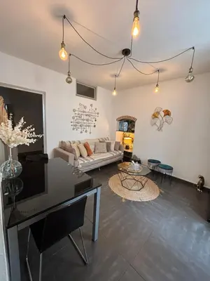 a living room with a couch and a table at Appartement F3 hyper centre in Ajaccio