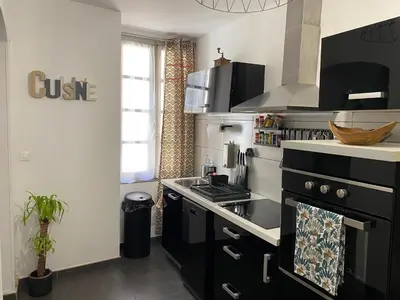 a kitchen with a black and white stove top oven at Appartement F3 hyper centre in Ajaccio