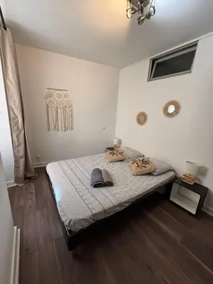 a bedroom with a bed with two hats on it at Appartement F3 hyper centre in Ajaccio