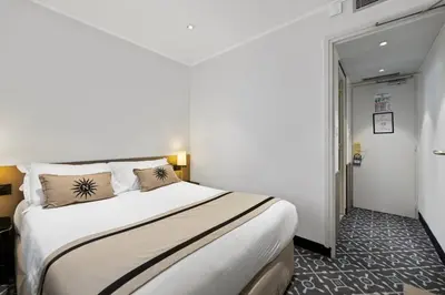 a bedroom with a large bed in a room at Napoleon in Ajaccio