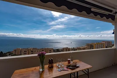 a large window with a view of the ocean at Magnifique appartement vue mer, spacieux et traversant in Ajaccio