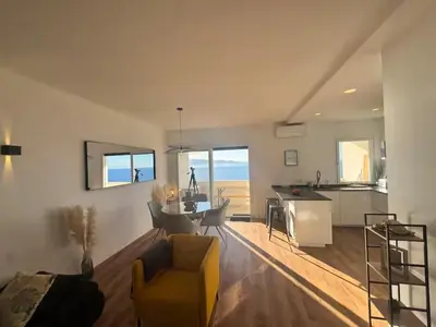 a living room with a bowl of fruit on a glass table at Magnifique appartement vue mer, spacieux et traversant in Ajaccio