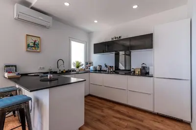 a bedroom with a large white bed with a picture on the wall at Magnifique appartement vue mer, spacieux et traversant in Ajaccio
