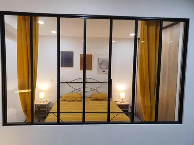 a reflection of a bedroom with a bed in a mirror at T2 Propriano vue mer, neuf, climatisé et classé 3 étoiles in Viggianello