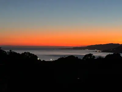 a view of the ocean at sunset at T3 Propriano vue mer, neuf, climatisé et classé 4 étoiles in Viggianello