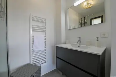 a bathroom with a sink and a mirror at Villa neuve et luxueuse vue mer proche Portovecchio in Zonza