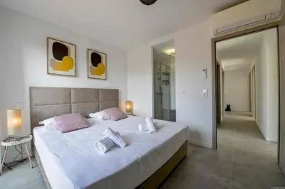 a bedroom with a large bed with two pillows on it at Villa neuve et luxueuse vue mer proche Portovecchio in Zonza