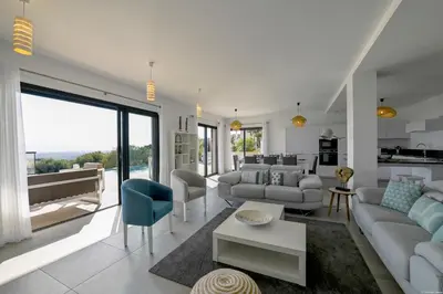 a living room with a couch and a table at Villa neuve et luxueuse vue mer proche Portovecchio in Zonza