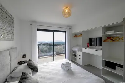 a living room with a couch and a large window at Villa neuve et luxueuse vue mer proche Portovecchio in Zonza