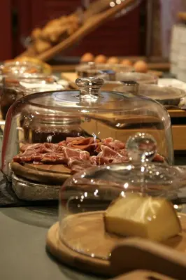 a display of food in a glass container on a table at Hôtel Albion in Ajaccio