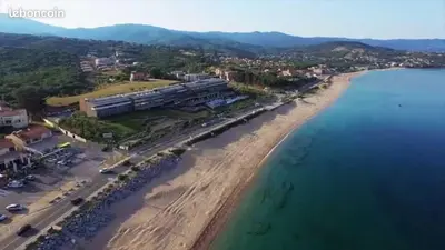 an aerial view of a beach next to the ocean at Résidence Mare Bellu Agosta plage in Porticcio
