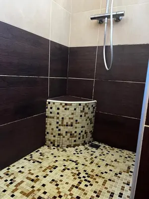 a bathroom with a shower and a tiled floor at Résidence Mare Bellu Agosta plage in Porticcio