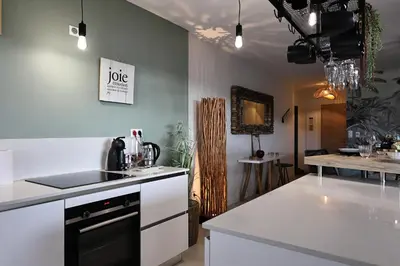 a kitchen with a sink and a stove at I Salini - T3 élégant & calme près du centre - Classé 4 étoiles in Porto-Vecchio