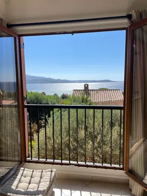 a balcony with a view of the ocean at Villa Bougainville in Porticcio