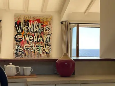 a vase sitting on a counter next to a window at Villa Bougainville in Porticcio