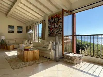 a living room with a view of the ocean at Villa Bougainville in Porticcio
