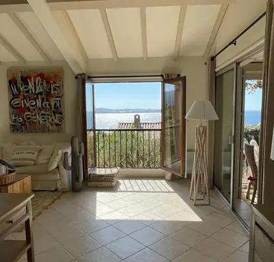 a living room with a view of the ocean at Villa Bougainville in Porticcio