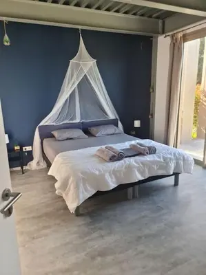a bedroom with a bed with two people laying on it at Villas Zanzimare Casa in Grosseto-Prugna