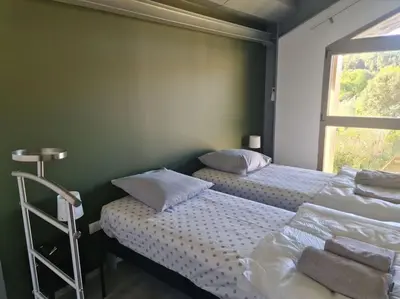 two beds in a room with a window at Villas Zanzimare Casa in Grosseto-Prugna