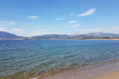 a view of a beach with mountains in the background at Villas Zanzimare Casa in Grosseto-Prugna