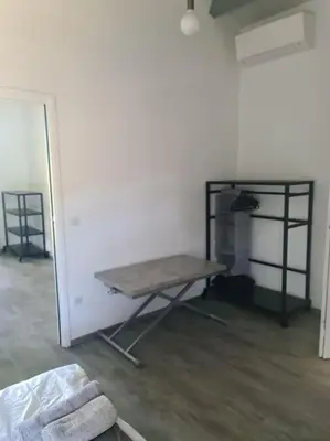 a room with a bed and a table and a shelf at Villas Zanzimare Casa in Grosseto-Prugna